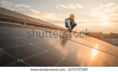 Service engineer checking solar cell on the roof for maintenance if there is a damaged part. Engineer worker install solar panel. Clean energy concept. Royalty-Free Stock Photo #2271737369
