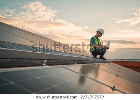 Service engineer checking solar cell on the roof for maintenance if there is a damaged part. Engineer worker install solar panel. Clean energy concept. Royalty-Free Stock Photo #2271737379