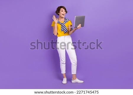 Full length photo of positive lady stylish clothes chatting friends followers arm greetings empty space isolated on purple color background