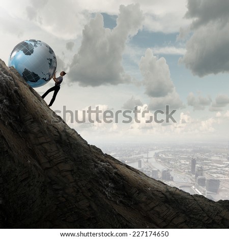 Young businesswoman rolling Earth planet up th hill