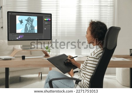 African American animator using graphic tablet and computer. Illustration on screen