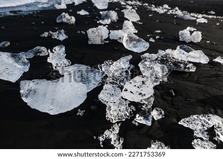 ice from a glacier on a background of magmatic black sand
