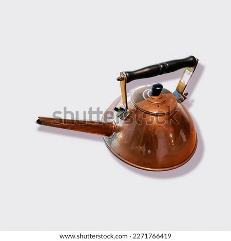 Vintage copper kettle on an isolated white background. Closeup of an old and antique bronze metal copper teapot. Ancient and luxurious for decoration table.