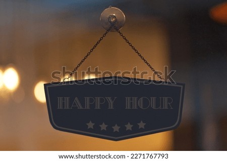 Trendy Happy Hour sign in a window.