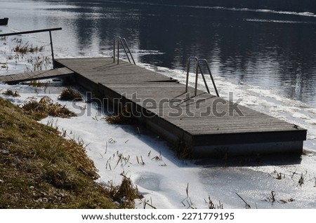 frozen river has modified entrances to water from  embankment. swimmer decides to take a bath as part of conditioning and hardening after sauna, it is possible to use stainless steel steps, ladder