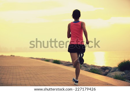 Runner athlete running at seaside. woman fitness silhouette sunrise jogging workout wellness concept. 