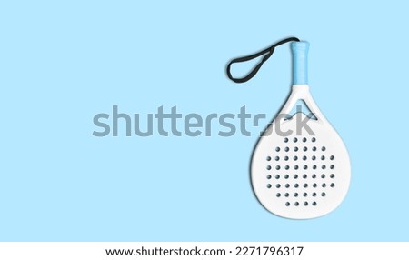 White professional paddle tennis racket on blue background. Horizontal sport theme poster, greeting cards, headers, website and app Royalty-Free Stock Photo #2271796317