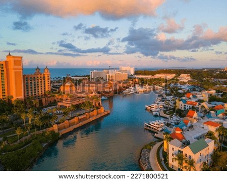 Harborside Villas aerial view at sunset with Atlantis Hotel at the background at Nassau Harbour, from Paradise Island, Bahamas. Royalty-Free Stock Photo #2271800521