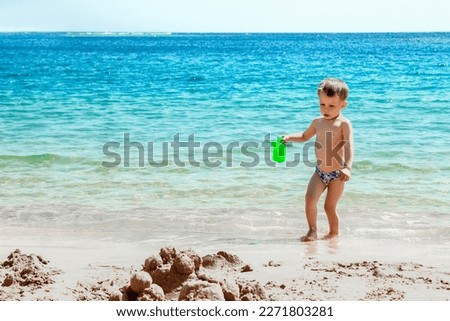 Happy child playing on the sea background