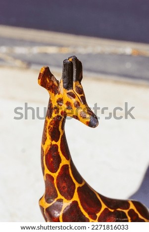 Wooden toy giraffe with long neck on white background. Exotic animal from a zoo, wild nature. A mascot from Africa Safari. Figurine, figure. statue for home decor. Animal toys for lids children play.