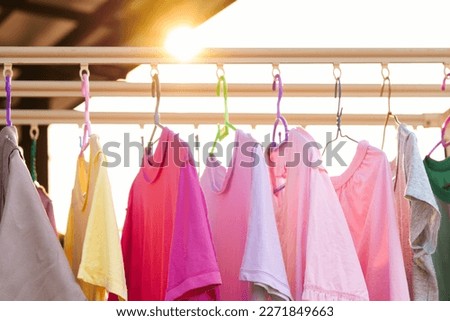 Hanging to dry Up Washing Colorful clothes on a laundry line and sun shining Royalty-Free Stock Photo #2271849663