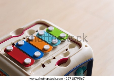 Close up colorful xylophone with blurry wooden floor background for children