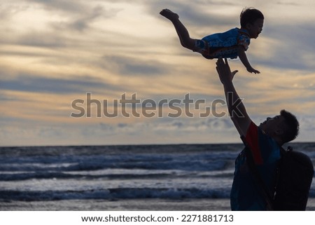Happy Father and son on the Beach. Kid having fun outdoors. Summer vacation and healthy lifestyle concept