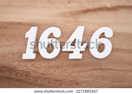 White number 1646 on a brown and light brown wooden background.