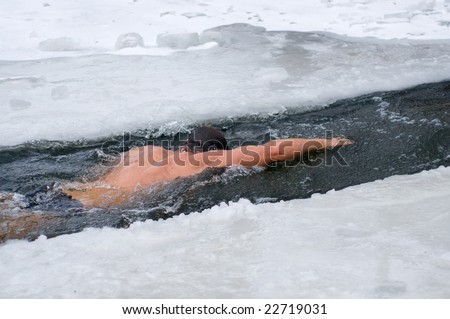 winter swimmer in the unfrozen patch of water