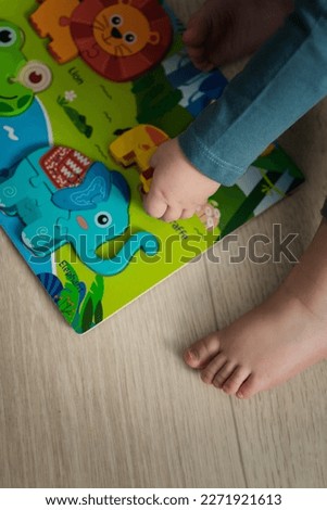 a small child is playing a board game