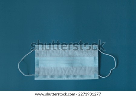 Medical three-layer mask on a blue background