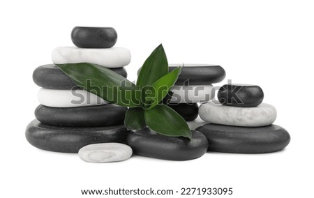 Stacks of spa stones and bamboo leaves on white background Royalty-Free Stock Photo #2271933095
