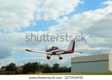 Modern ultralight airplane flying up from field
