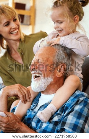 Cheerful multi-generation family having fun while spending time together at home. Royalty-Free Stock Photo #2271968583