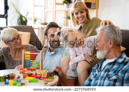 Cheerful multi-generation family having fun while spending time together at home. Royalty-Free Stock Photo #2271968593