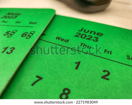 June calendar with May in the background concept with green background  Royalty-Free Stock Photo #2271983049