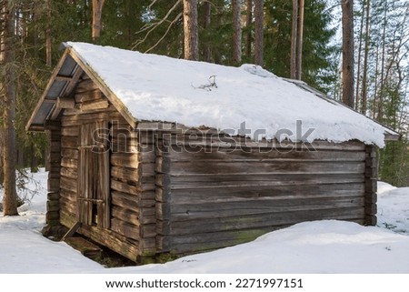 Old timbered barn in the forest on a sunny winter day, picture from vasternorrland Sweden.