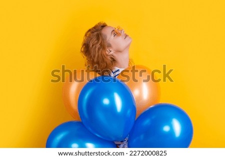 party woman with balloon in sunglasses. woman hold party balloons in studio. woman with balloon