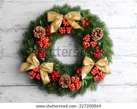 Christmas decorative wreath with leafs of mistletoe on wooden background
