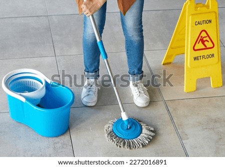 Floor mopping, cleaning sign and mop bucket with water and woman doing safety and hygiene work. Wellness, female worker and maid with disinfection container and tile ground with cleaner and janitor