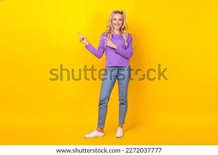Full length photo of funny adorable lady dressed purple shirt showing two fingers emtpy space isolated yellow color background