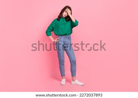 Full length photo of tired unhappy sad woman wavy hairdo wear green shirt denim pants hold palm on forehead isolated on pink background Royalty-Free Stock Photo #2272037893