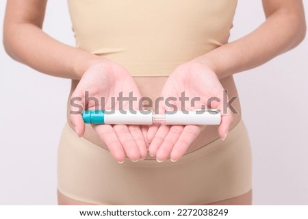 Close up woman using IVF treatment injection on belly to prepare reproductive fertility , Ovulation stimulation .	 Royalty-Free Stock Photo #2272038249