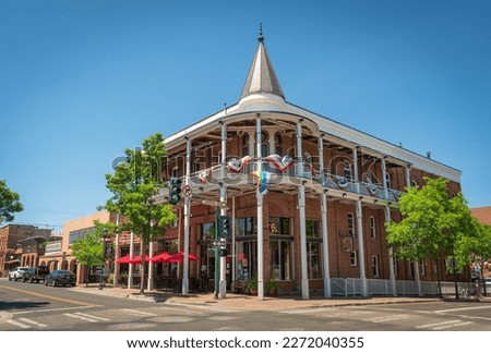 Festive building at Flagstaff, Arizona with American and LGBT flags. Royalty-Free Stock Photo #2272040355