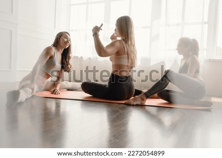 Attractive young sporty girls doing pilates together Royalty-Free Stock Photo #2272054899