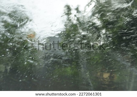 blurred image or not focused of car window glass exposed to water