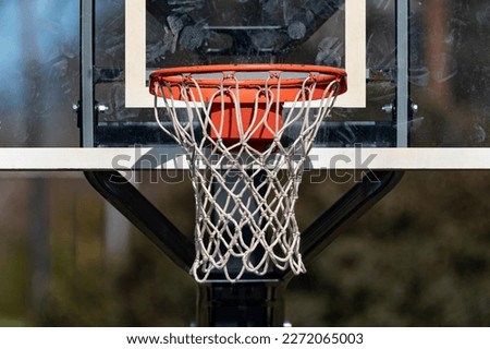 Close up of an isolated basketball goal net and backboard with a shallow depth of field