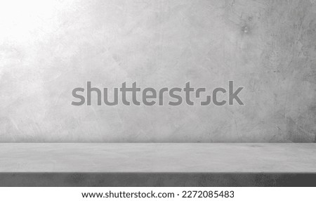 Grey Cement Wall Background and Empty Rough Floor shelves with soft light Studio well Material display Production Background and text present on free space Gray color,Backdrop Background 
