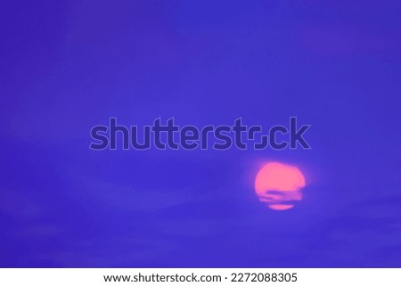 The pink sun against the blue dusk sky. Color of nature twilight.