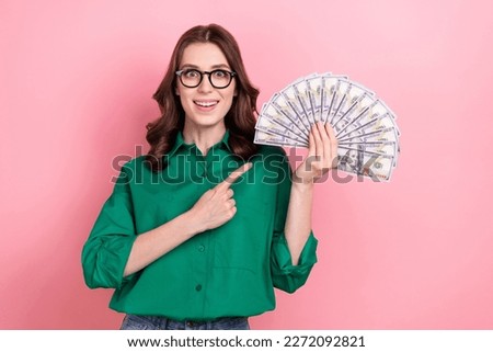 Portrait of shocked positive person indicate finger hand hold usd dollar bills banknotes isolated on pink color background