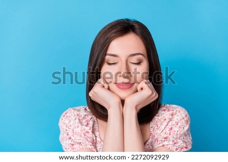 Closeup photo of young dreamy sleeping woman hold cheeks happy positive isolated on blue color background