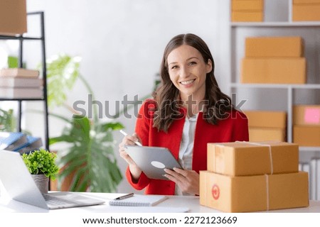 Female ecommerce business owner prepares package box for customer and delivery check balance. SME. Royalty-Free Stock Photo #2272123669