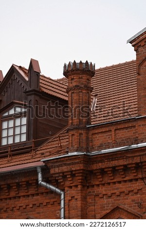 pitched red tile roof of a historic building