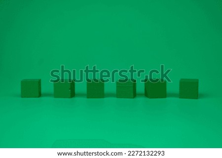 A row six wood geometric shapes cube in the green background.