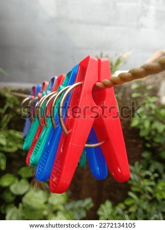 Colorful clothespins and plastic ropes on a blurred background