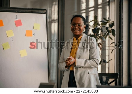 In the Corporate Meeting Room: Female Analyst Uses Interactive Whiteboard for Presentation to a Board. Whiteboard Shows the Company's Business Ideas