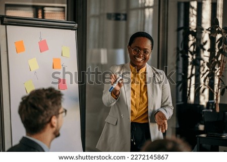 Shot of a young businesswoman delivering a presentation to her colleagues in the boardroom of a modern office.