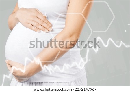 Happy pregnant woman with chart of hormone level Royalty-Free Stock Photo #2272147967