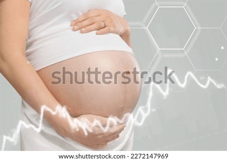 Happy pregnant woman with chart of hormone level Royalty-Free Stock Photo #2272147969