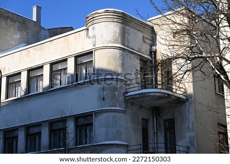 apartment building with a rounded corner and a semi-circular balcony
